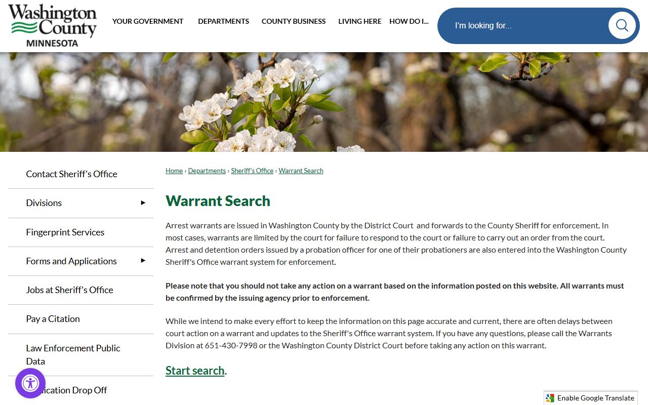 County warrant search landing page with warning, Warrants Division phone, and District Court confirmation reminder